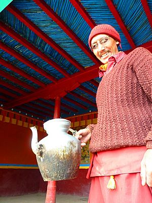 Monk with pot of butter tea at Key Monastry, Spiti, India