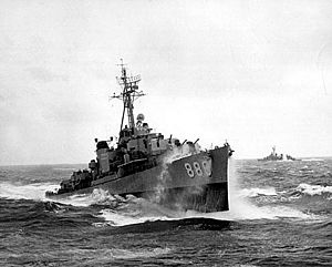 USS Orleck (DD-886) underway in heavy seas, in the 1950s