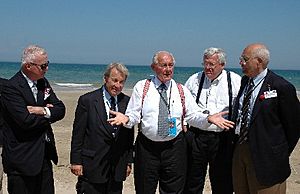 Amo Houghton stands on Utah Beach with other congressional World War II veterans and the Speaker of the House