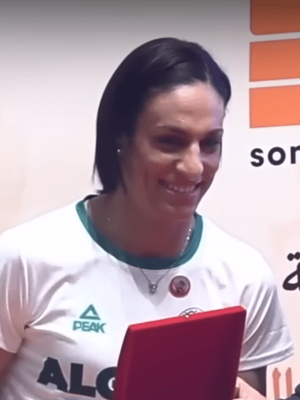 Imane Khelif wearing a gold medal at a sports competition.