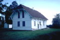 alt=A small white building.