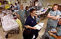 US Navy 030423-N-6967M-235 Hospital Corpsman Wade Henry gives a passdown to the night shift in the Intensive Care Unit (ICU) aboard USNS Comfort (T-AH 20)