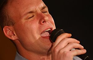 US Navy 060326-5961C-N-001 Intelligence Specialist 2nd Class Jarrod Fowler performs during the Ronald Reagan Idol talent competition, March 26, 2006