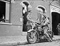 A motorcycle despatch rider delivers a message to the signals office of 1st Border Regiment at Orchies, France, 13 October 1939. O129