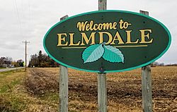 sign reading "Welcome to Elmdale" illustrated with two large elm leaves