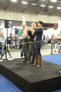 Instructor fly fishing shows a woman fly casting