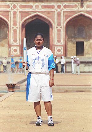 The weightlifter Karnam Malleswari bronze medallist at the Sydney Olympic Games 2000, with the Olympic flame at Humanyun's Tomb during the Olympic Torch Relay 2004 in New Delhi on June 10, 2004.jpg