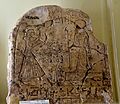 Upper part of a stela showing a standing man adoring Ra-Horakhty who holds a was-sceptre. 19th Dynasty. From Egypt. The Petrie Museum of Egyptian Archaeology, London