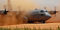 C-130 Hercules performs a tactical landing on a dirt strip