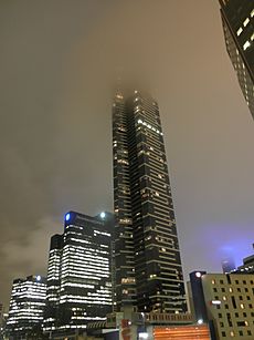 Eureka Tower covered in low clouds at night