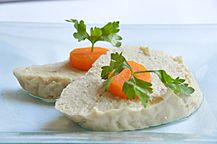 Gefilte fish topped with slices of carrot