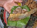 Kao hnyin baung - cooked glutinous rice with fried fish on a banana leaf.jpg