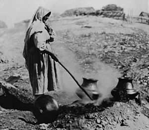 Sara Fina Tafoya firing blackware pottery at Santa Clara Pueblo, c. 1900