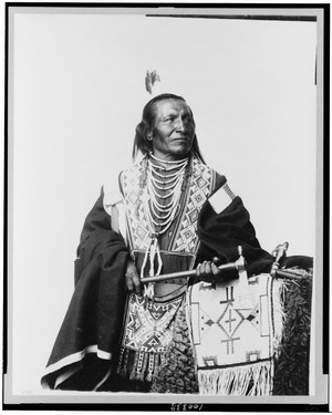 Chief Red Fox, Sioux(?) Indian, three-quarter length portrait, standing, facing right, holding tomahawk LCCN90712016