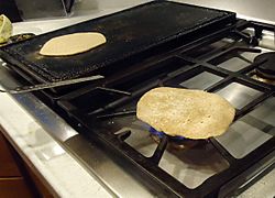 Cooking a chapati (sp) on open flame