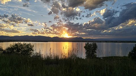 A sunset over Stanley Lake in Westminster, Colorado