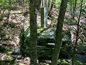 Connecticut-Massachusetts state line boundary marker in Sages Ravine near Connecticut Route 41 and Mount Riga State Park.jpg