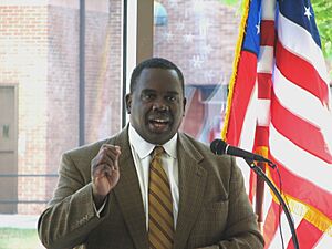 Albert Wynn speaking at podium