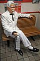 Colonel Sanders statue sitting on bench
