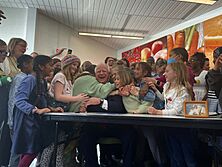 Minnesota Governor Tim Walz getting hugged by children after signing universal free school meals into law