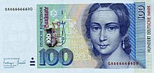 Banknote in light blue with green and beige, focused on the face of a young woman on the right, dark blue drawing on light blue
