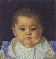 Head and shoulders portrait of an infant boy wearing a white bib