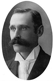 Black and white image of man with large moustache and short hair