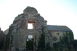 Stone wall with window of ruined building