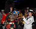 US Navy 070907-N-5174T-005 Musician 3rd Class Helena Giammarco, a Pacific Fleet band member, plays the French horn backstage with a friend from the Royal Regiment of Scotland following the second night of performances at the Ku