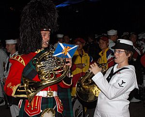 US Navy 070907-N-5174T-005 Musician 3rd Class Helena Giammarco, a Pacific Fleet band member, plays the French horn backstage with a friend from the Royal Regiment of Scotland following the second night of performances at the Ku