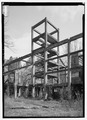 EXTERIOR VIEW, LOOKING NORTHEAST, WITH CONCRETE-CLAD STRUCTURAL FRAME. - Shelby Iron Works, Structural Framing, Chemical Plant No. 1, County Road 42, Shelby, Shelby County, AL HAER ALA,59-SHEL,1C-1