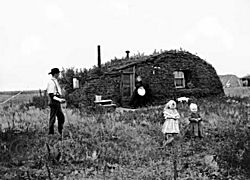 Settlers in front of their sod house in Milton in 1898