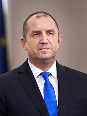 Portrait photograph of Radev, 55, wearing a black suit and a blue tie.