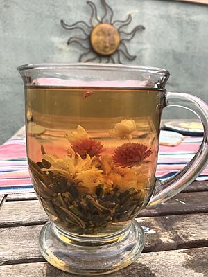 Green tea with blossoming flower
