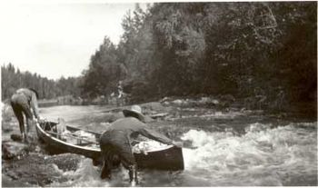 Robert Tobacco and Harold Wells Lining their Canoe up Tracking Rapids on the Goose River.jpg