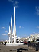 A White statue in front of Library of Alexandria