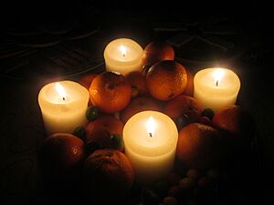 Candle lighting a plate of oranges and smarties 1