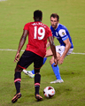 Fernando Recio, player of Kitchee SC, in action against Danny Welbeck