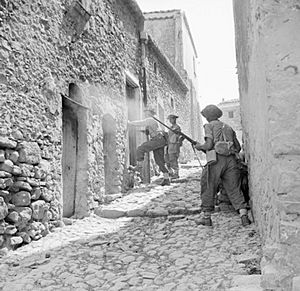 Men of the 6th Inniskillings, 38th Irish Brigade, searching houses during mopping up operations in Centuripe, Sicily, August 1943. NA5388