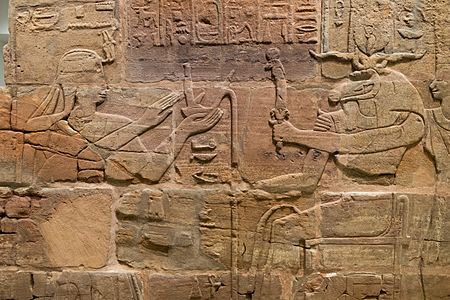 Sandstone wall of King Aspelta offering Ma'at (Truth) to ram-headed god Amun-Re accompanied by Anukis, Temple T at Kawa