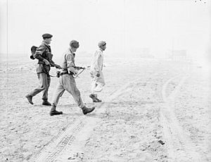 Troops of 3rd Battalion Parachute Regiment escort a captured Egyptian soldier on the beach at Port Said