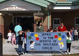 US Navy 070401-N-1082Z-001 Lois Davis, training and curriculum supervisor for Naval Air Station (NAS) Oceana Child Development Center (CDC), leads a parade along with education technicians Julia Yarbrough and Alice Fernandez