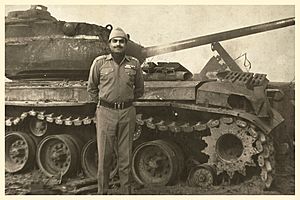 Vohra posing in front of a destroyed Pakistani Patton tank