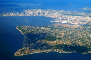 Aerial view of Alki Point in Seattle. Elliott Bay and Downtown Seattle can be seen in the background.