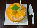 A well decorated mango flavoured cake during birthday celebration