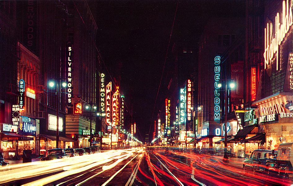 Broadway signs at night looking south from 5th Street, Los Angeles, 1950s