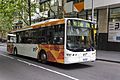 A Transdev Melbourne bus in orange and white PTV livery.