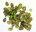 Peridot (Mg, Fe)2SiO4 in the rough form and a cut and polished gem - Sara Abey