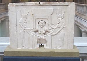 Plaque of a woman giving birth assisted by Hathor