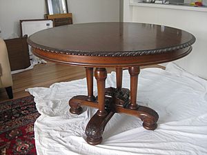 “Circular Dining Table, by Francis de Groot, with four (not three) column supports and shaped base with acanthus carving, diameter 4 feet (1.2192 metres)”